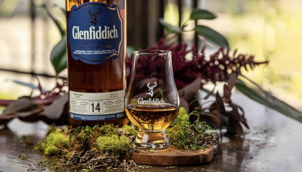 Glenfiddich 14 year reserve bottle and glass on table